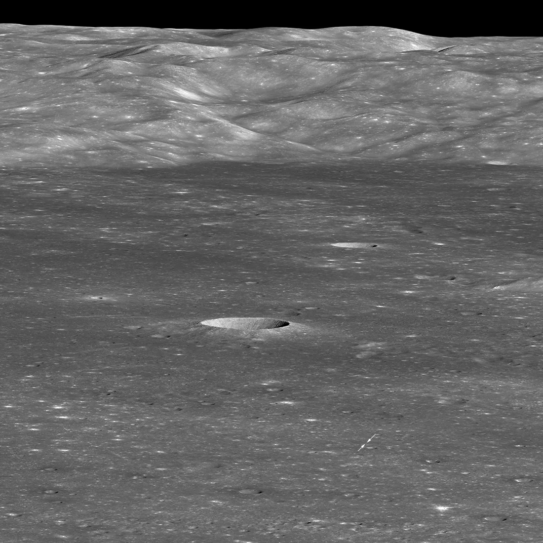 LRO view across the floor of Von Kármán crater toward its western wall, with the Chang'e 4 landing location marked